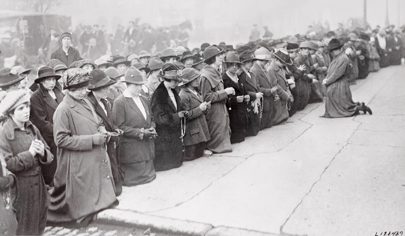 Citizens kneeling to pray in the City of Dublin.