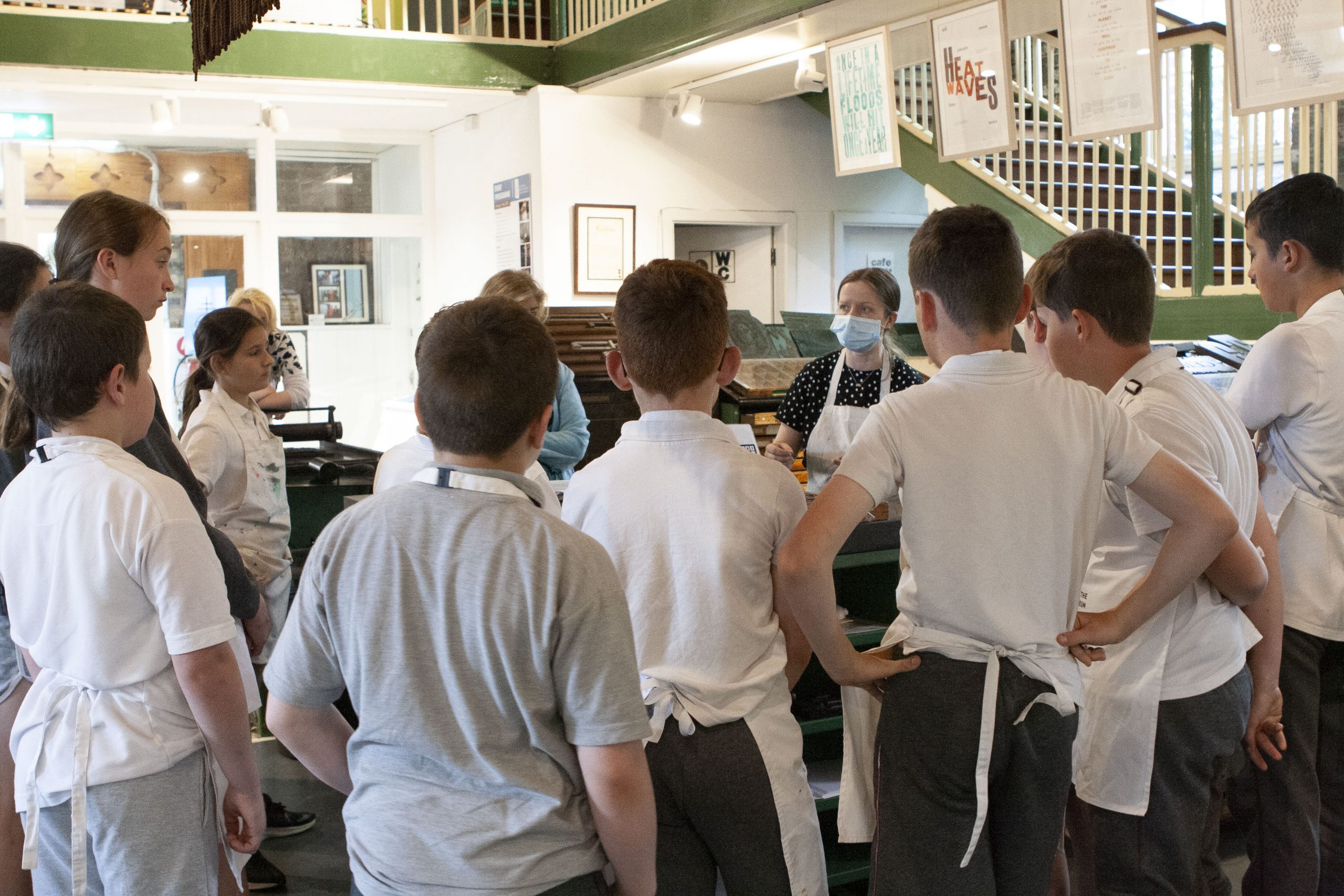 Mary Plunkett discussing the printing process with students from Glenbeg National School.